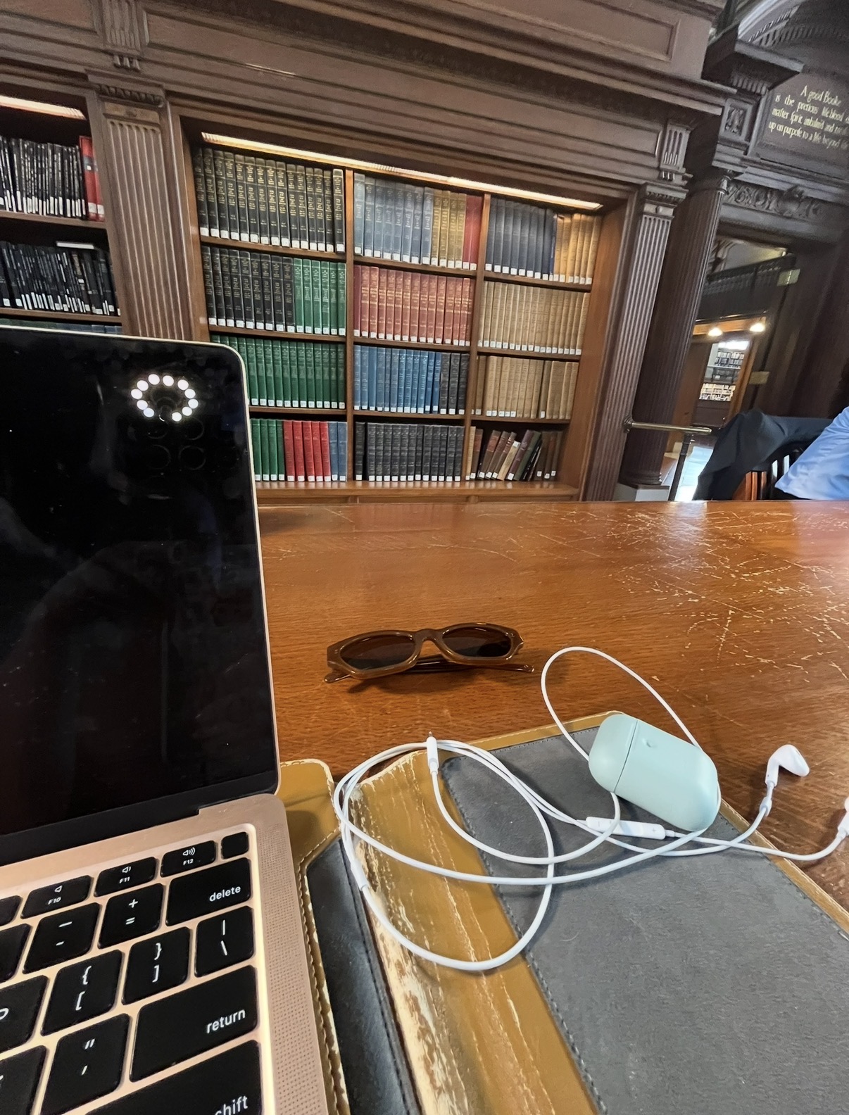 Laptop and notebooks on a library table
